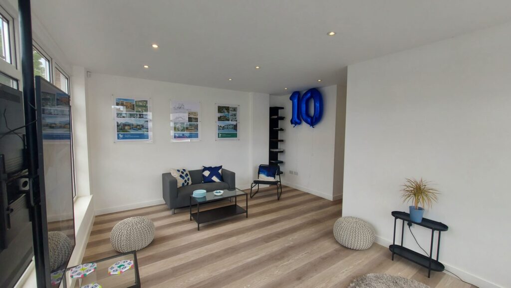 Sevenoaks Plans Celebrating 10 Years of Success. An open room with a number 10 balloon, with table set out ready to begin celebrations.
