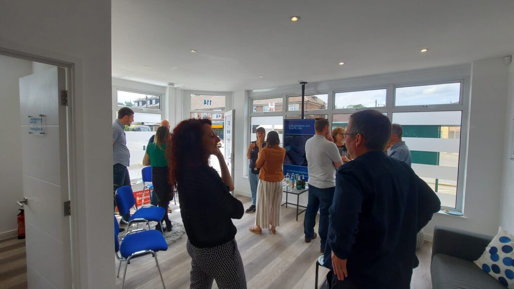 Sevenoaks Plans celebrating 10 years of success. A room full of people talking and enjoying themselves.